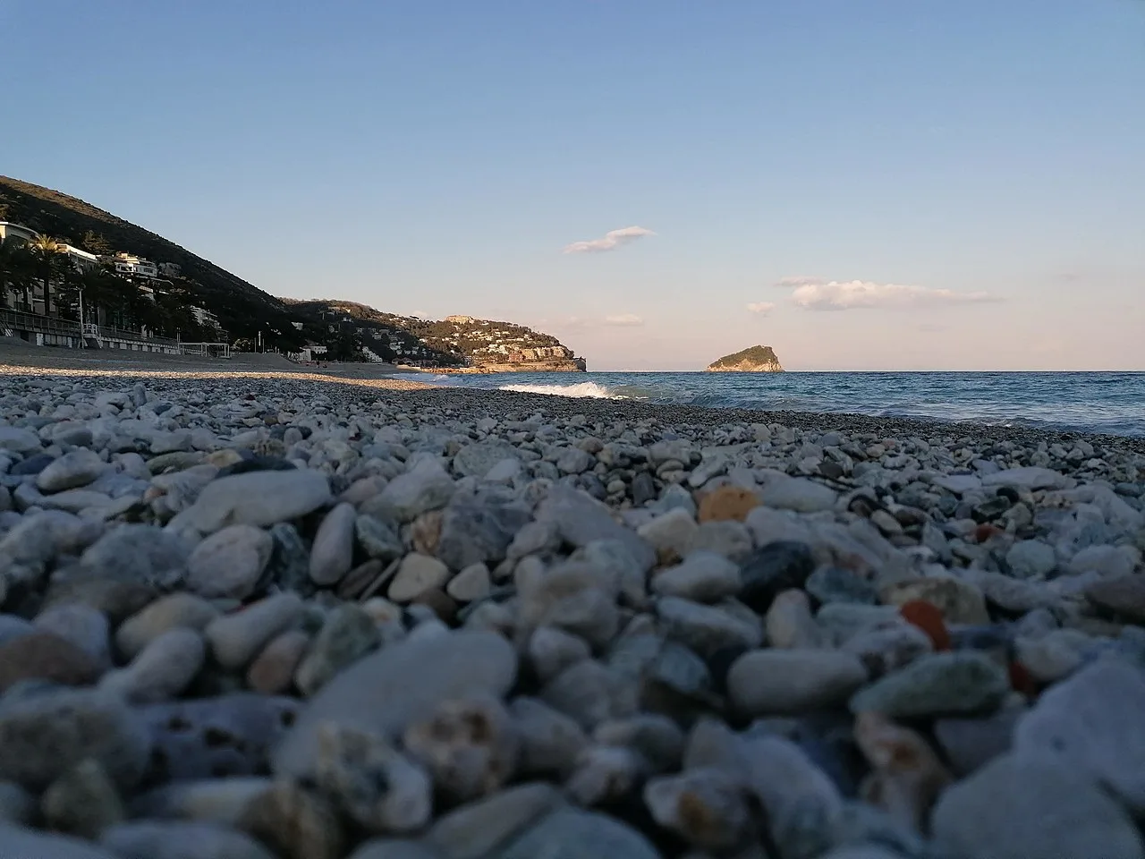 La spiaggia di Spotorno con il mare aperto e l'isola di Bergeggi sullo sfondo