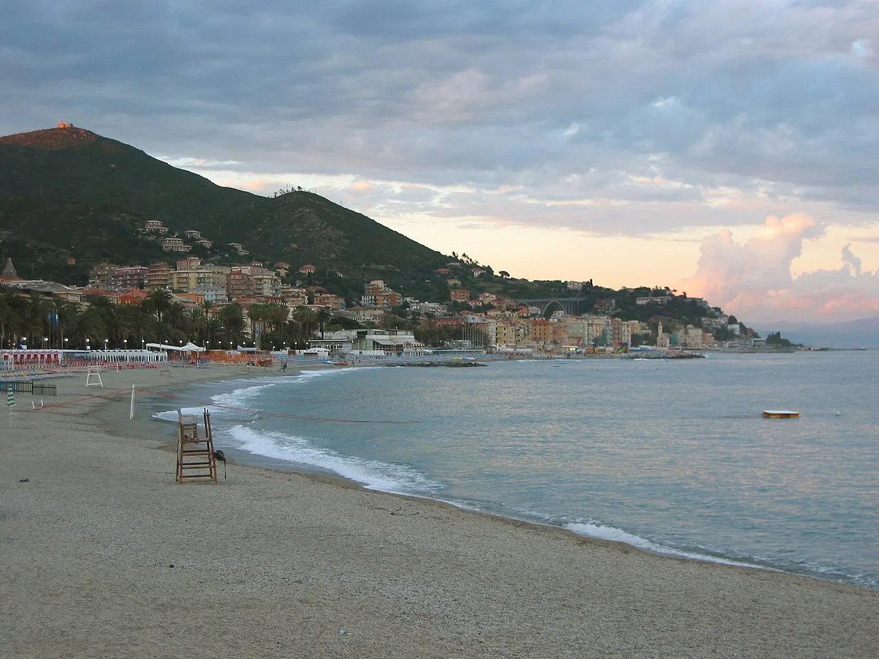La spiaggia di Varazze al tramonto, con il mare calmo e la luce dorata della sera